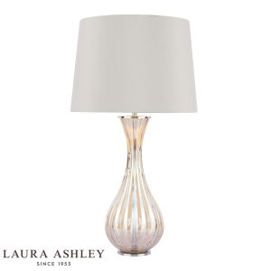 Laura Ashley Nevern champagne glass table lamp with shade, on white background, lit.