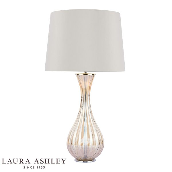 Laura Ashley Nevern champagne glass table lamp with shade, on white background, lit.