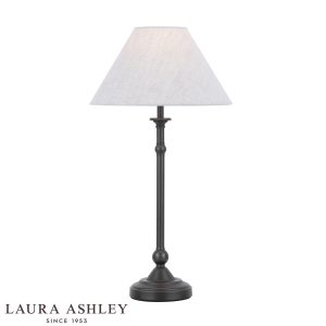Laura Ashley Ludchurch candlestick table lamp in industrial black, on white background, lit.