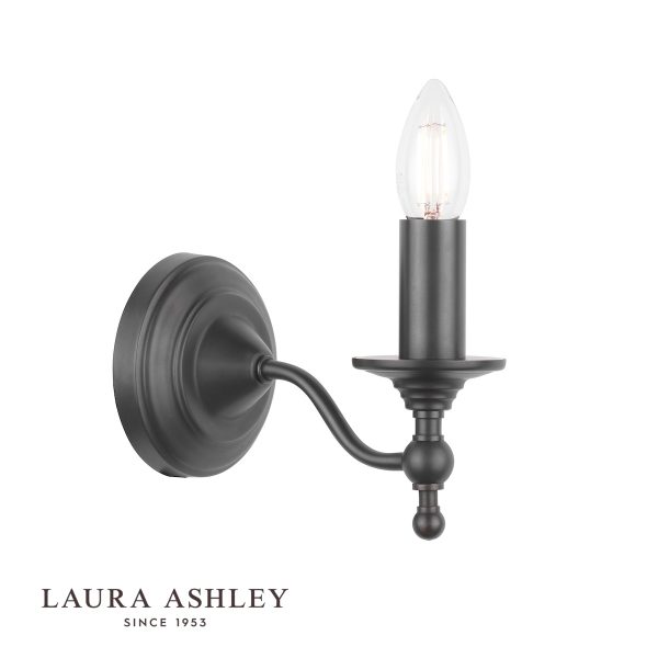 Laura Ashley Ludchurch single wall light in industrial black on white background, lit.