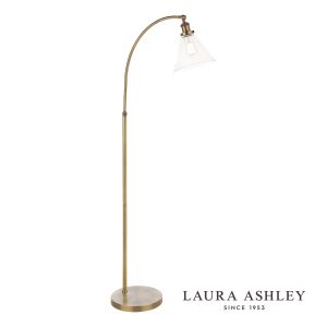 Laura Ashley Isaac floor lamp in antique brass finish with clear glass shade on white background.