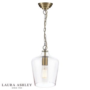 Laura Ashley Ockley 1 light champagne glass pendant in antique brass, shown lit on white background.