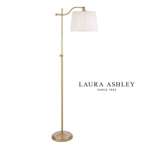 Laura Ashley Hemsley adjustable floor lamp in matt antique brass on white background, lit.