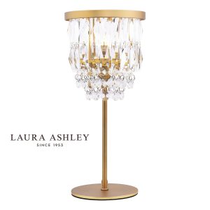 Laura Ashley Rhosill crystal table lamp in matt antique brass on white background, lit.