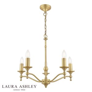 Laura Ashley Ludchurch 5 light chandelier in matt antique brass, on white background, lit.