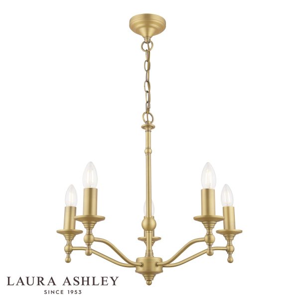 Laura Ashley Ludchurch 5 light chandelier in matt antique brass, on white background, lit.