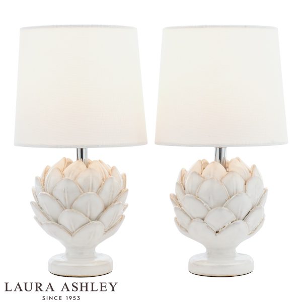 Laura Ashley white ceramic Artichoke table lamp with ivory linen shade, twin pack on white background, lit.