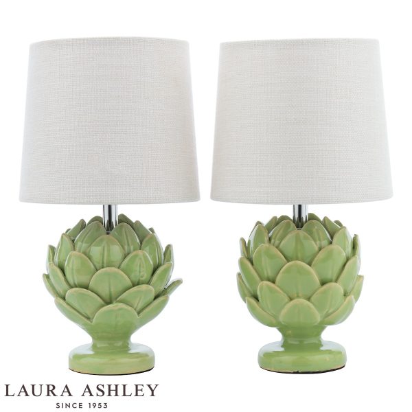 Laura Ashley green ceramic Artichoke table lamp with ivory linen shade, on white background unlit.