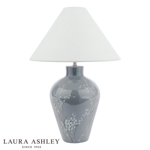 Laura Ashley Pussywillow grey ceramic table lamp with silver linen shade, on white background.