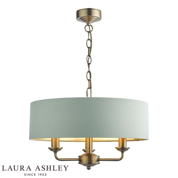 Sorrento 3 light chandelier in matt antique brass finish with green velvet drum shade, full height on white background, lit.