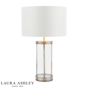 Harrington small glass table lamp in antique brass finish with ivory linen shade by Laura Ashley, on white background, lit.
