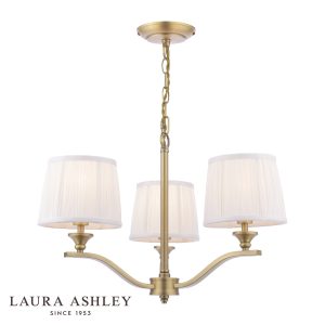 Laura Ashley Hemsley 3 light chandelier in matt antique brass on white background, lit.