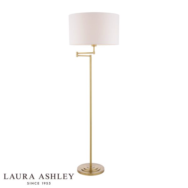 Laura Ashley Marlowe swing arm floor lamp in antique brass on white background, lit.