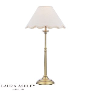 Laura Ashley Cordwell table lamp in matt antique brass on white background, lit.