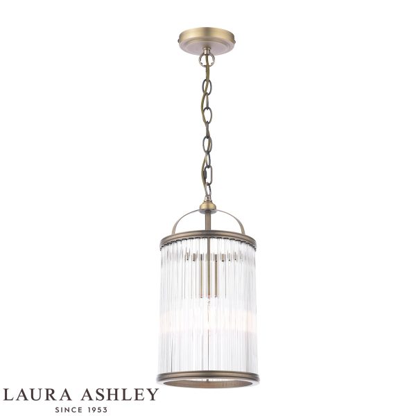 Sutton single light pendant in matt antique brass finish with clear glass rods by Laura Ashley, full height on white background, lit.
