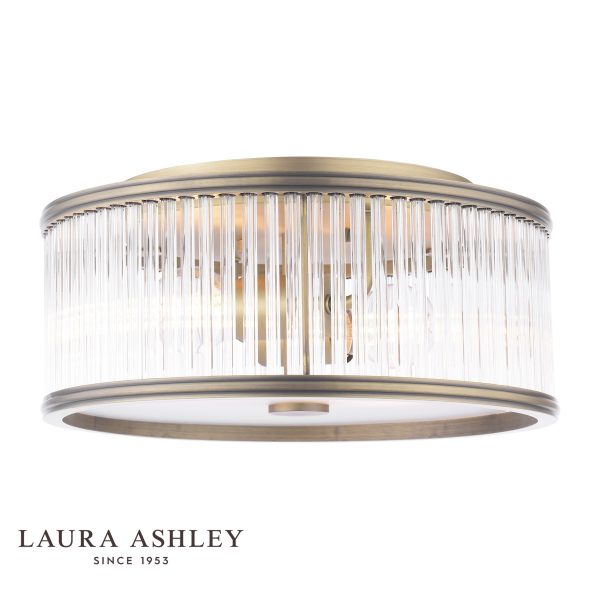 Sutton 2 light flush ceiling light in matt antique brass finish with clear glass rods by Laura Ashley, on white background, lit.
