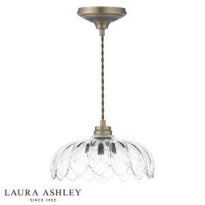 Bexwell 1 light pendant in matt antique brass finish with glass shade on white background.
