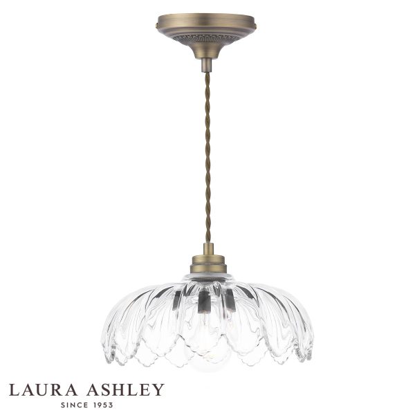 Bexwell 1 light pendant in matt antique brass finish with glass shade on white background.