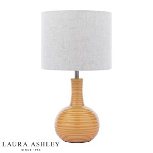 Laura Ashley Padley yellow ceramic table lamp with natural linen shade, on white background.
