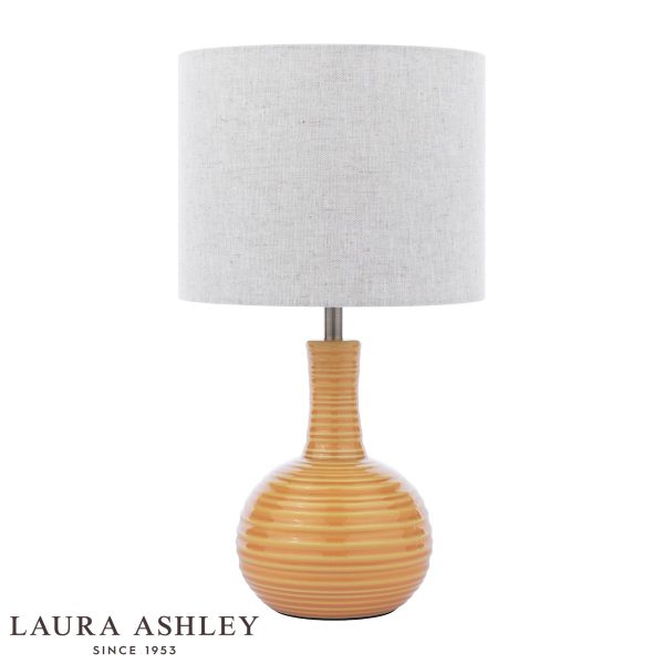 Laura Ashley Padley yellow ceramic table lamp with natural linen shade, on white background.