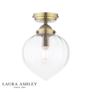 Whitham 1 light flush bathroom ceiling light in antique brass finish, on white background, lit.