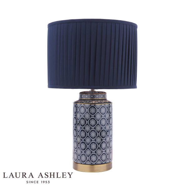 Laura Ashley Knipton blue ceramic table lamp with shade on white background, lit.