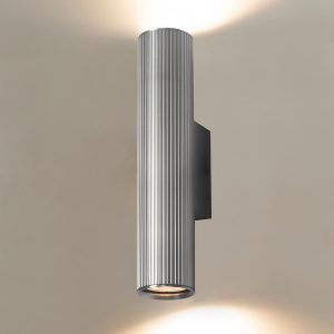 Franklite Scout modern up and down wall light in satin nickel, on cream background, lit.