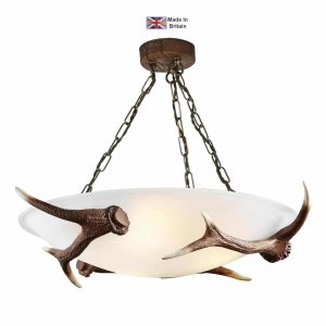 3 bulb semi flush Antler ceiling light with alabaster glass in a rustic finish on white background lit