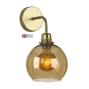 Apollo 1 light solid butter brass single wall light with amber glass shade on white background lit