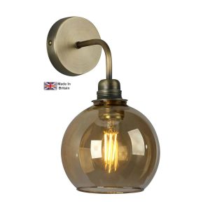 Apollo 1 light solid antique brass single wall light with amber glass shade on white background lit