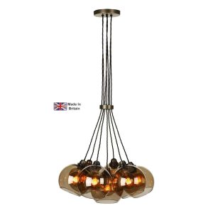 Apollo 7 light cluster pendant in solid antique brass with amber glass shades on white background lit