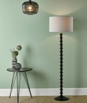 Azana wooden floor lamp standard in matt black with white linen shade in living room setting