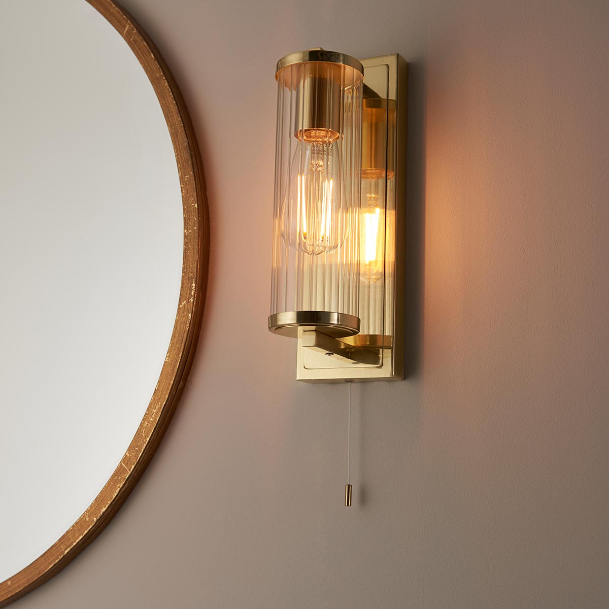 Cylinder Switched Bathroom Wall Light Brushed Brass Clear Glass Shade