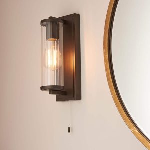 Cylinder switched bathroom wall light in dark bronze with clear glass shade main image