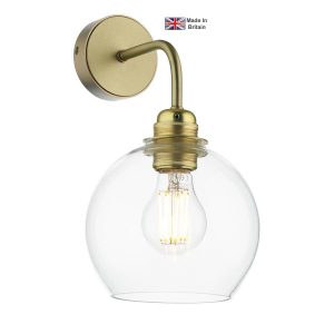Apollo 1 light solid butter brass single wall light with clear glass shade on white background lit