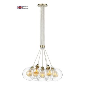Apollo 7 light cluster pendant in solid butter brass with clear glass shades on white background lit