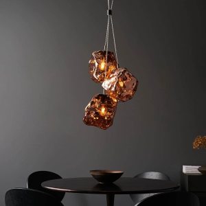 Endon Rock 3 light cluster pendant with copper volcanic glass shades low over table
