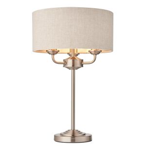 Highclere 3 light table lamp with natural linen shade in brushed chrome on white background