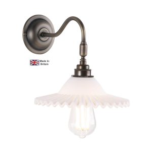 Finchley single wall light in solid antique brass with crimped edge glass shade on white background lit