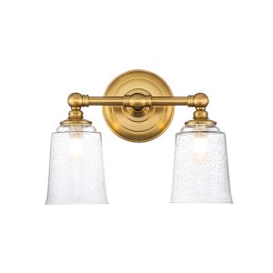 Feiss Huguenot Lake double bathroom mirror light in burnished brass finish on white background, lit.