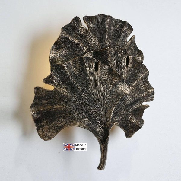 Gingko leaf single wall washer light in black and gold on white background lit