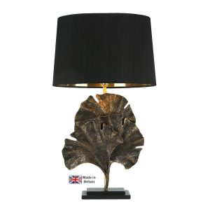 Gingko leaf table lamp in black and gold on white background lit