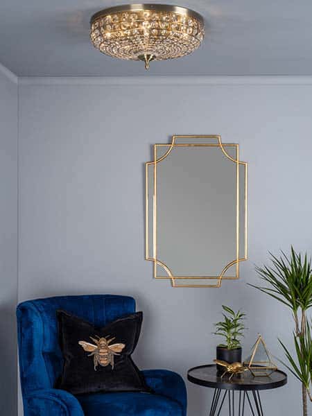 Asmara antique brass flush ceiling light in sitting room lit.