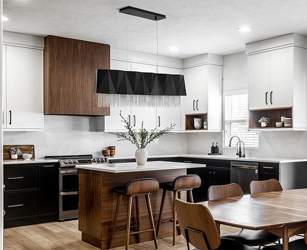Modern kitchen with ultra modern LED pendant hanging over kitchen island.