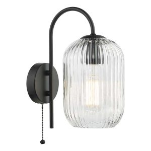 Idra single switched wall light with clear ribbed glass shade in matt black on white background lit