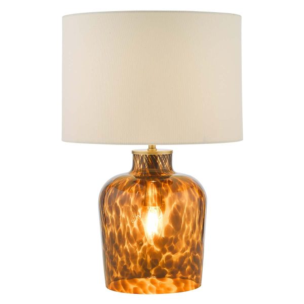 Leandra dual light tortoiseshell glass table lamp with white linen shade, on white background lit