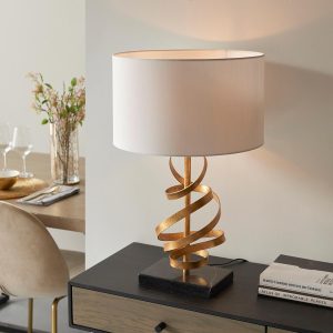 Contemporary 1 light gold leaf ribbon table lamp with ivory cotton shade on table
