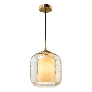Majella single champagne glass pendant light with antique brass metalwork, on white background lit