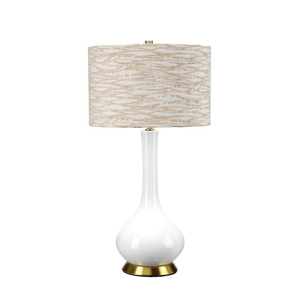 Milo white ceramic table lamp with aged brass metalwork and linear light orange patterned shade on white background.