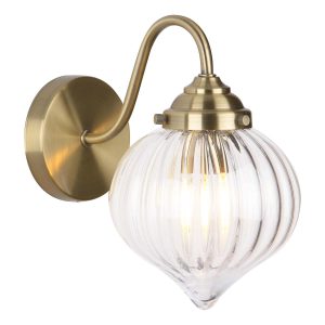 Mya single wall light with ribbed clear glass shades in antique brass, on white background lit